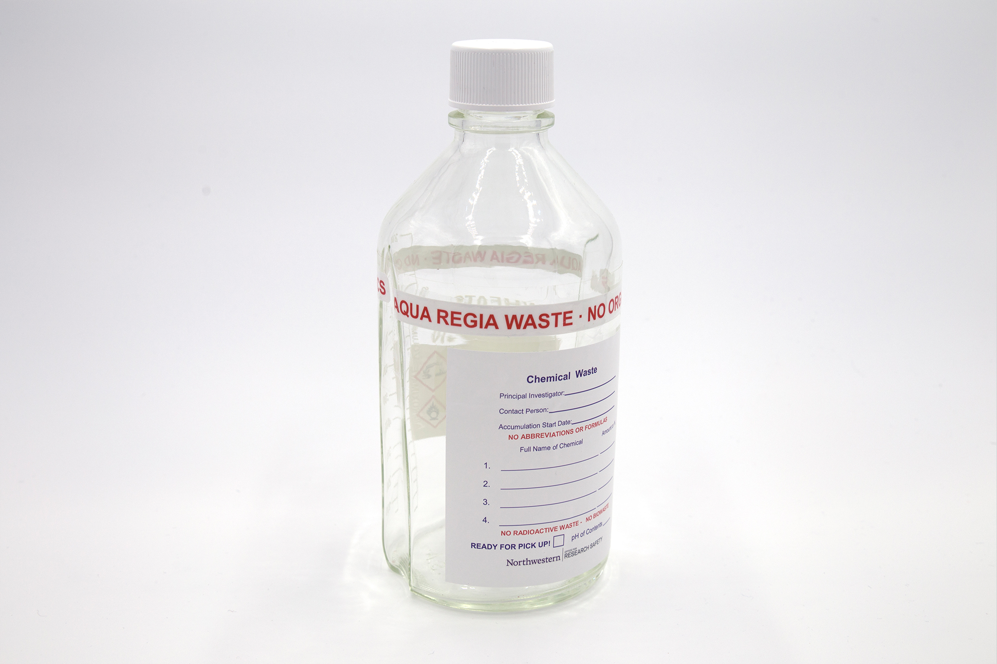 Clear glass bottle with aqua regia waste label.