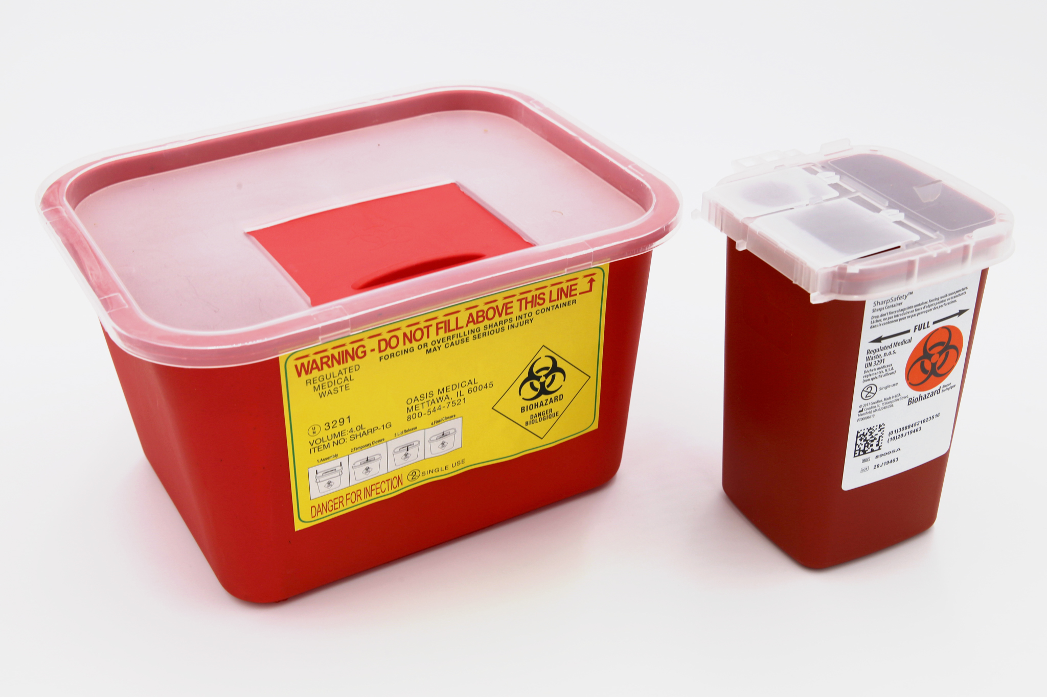 Two red biohazard sharps containers on a white background