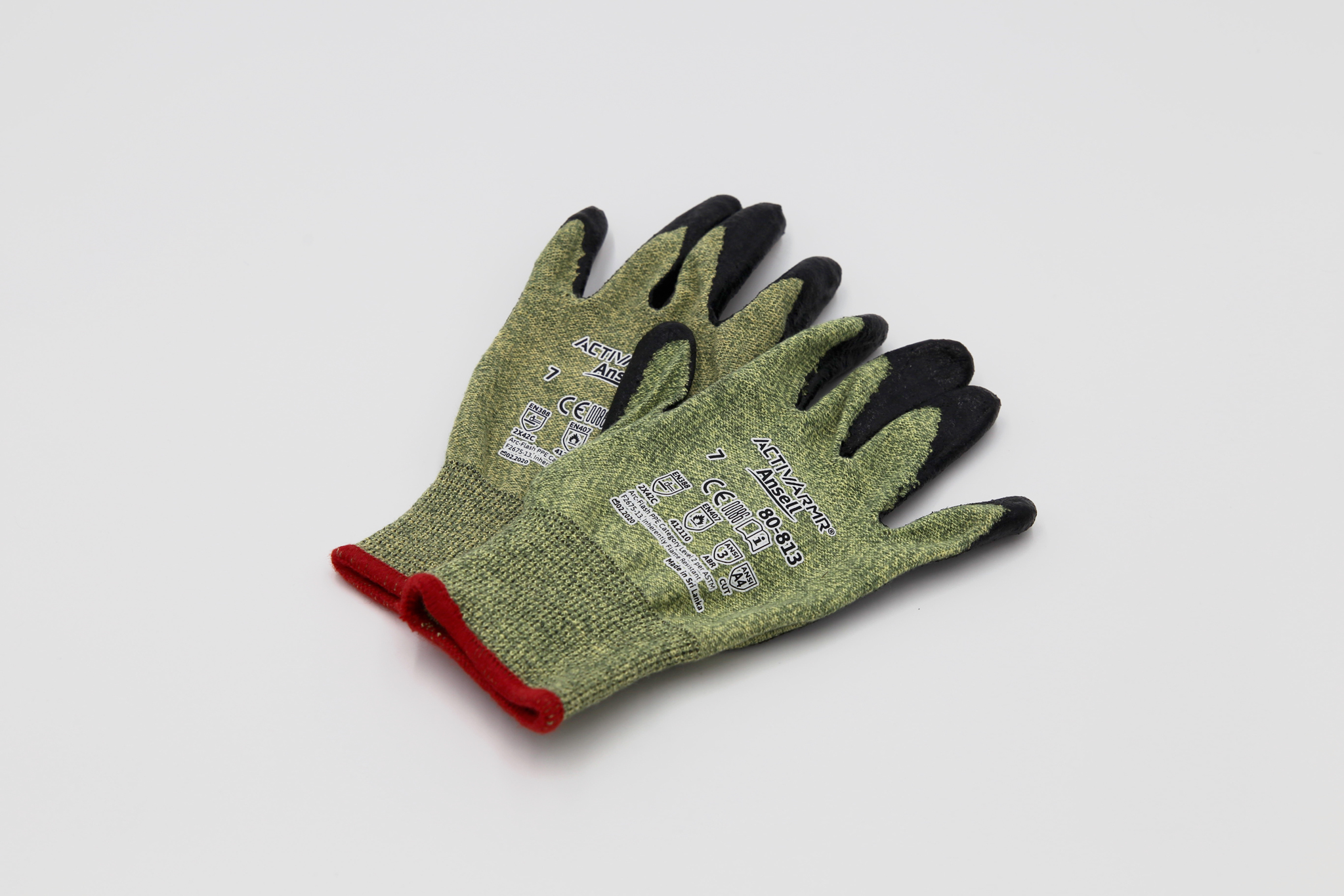 green cut resistant gloves on white background