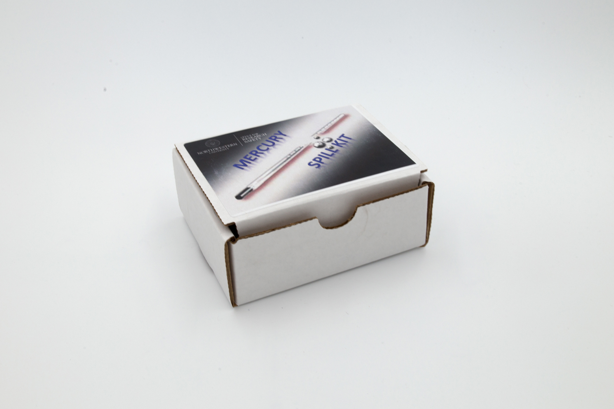 Cardboard box with mercury spill kit inside on white background