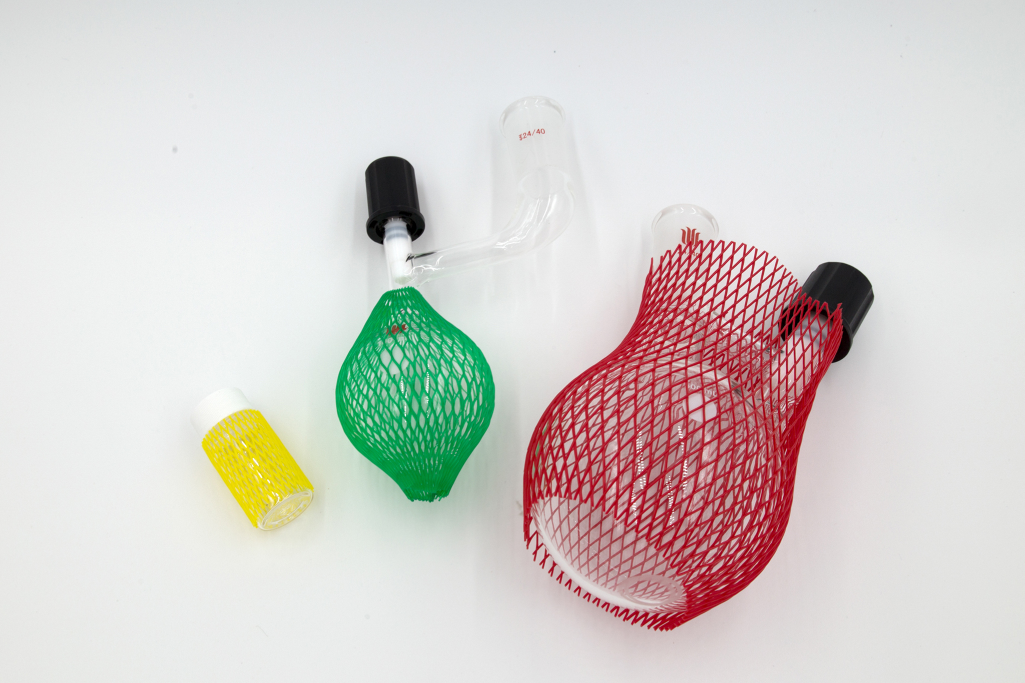 Three laboratory glasswares with protective netting on a white background