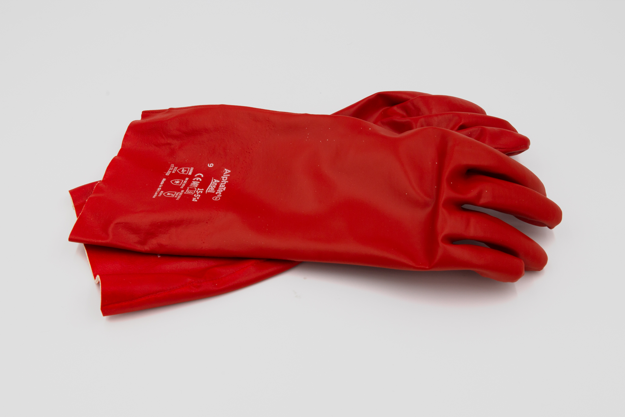 Red rubber gloves on white background