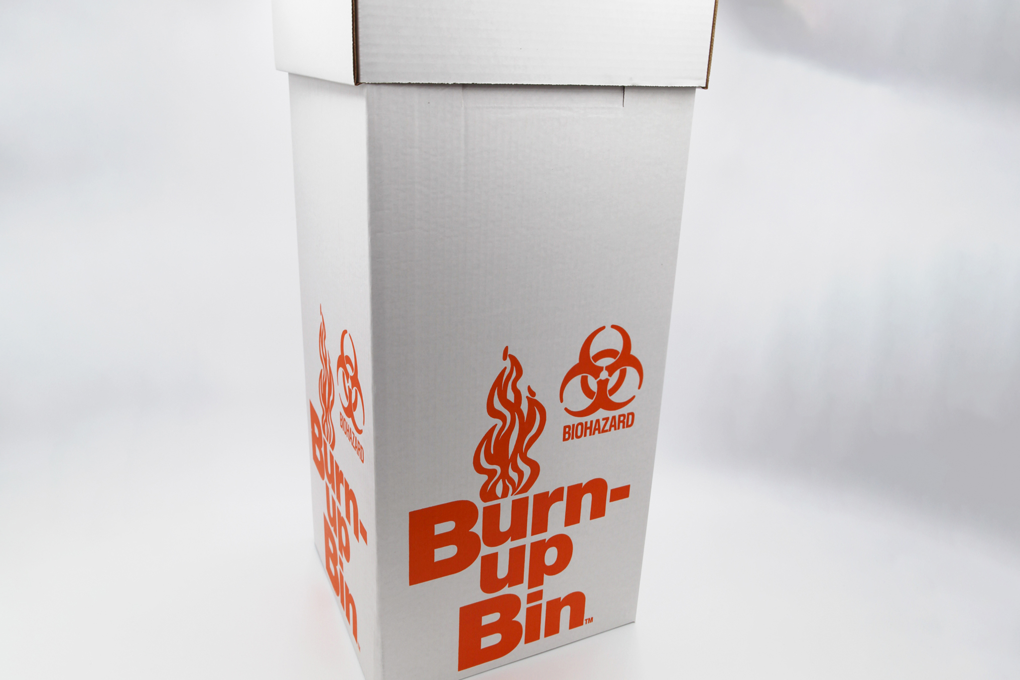 Tall white cardboard box with the text "burn bin"