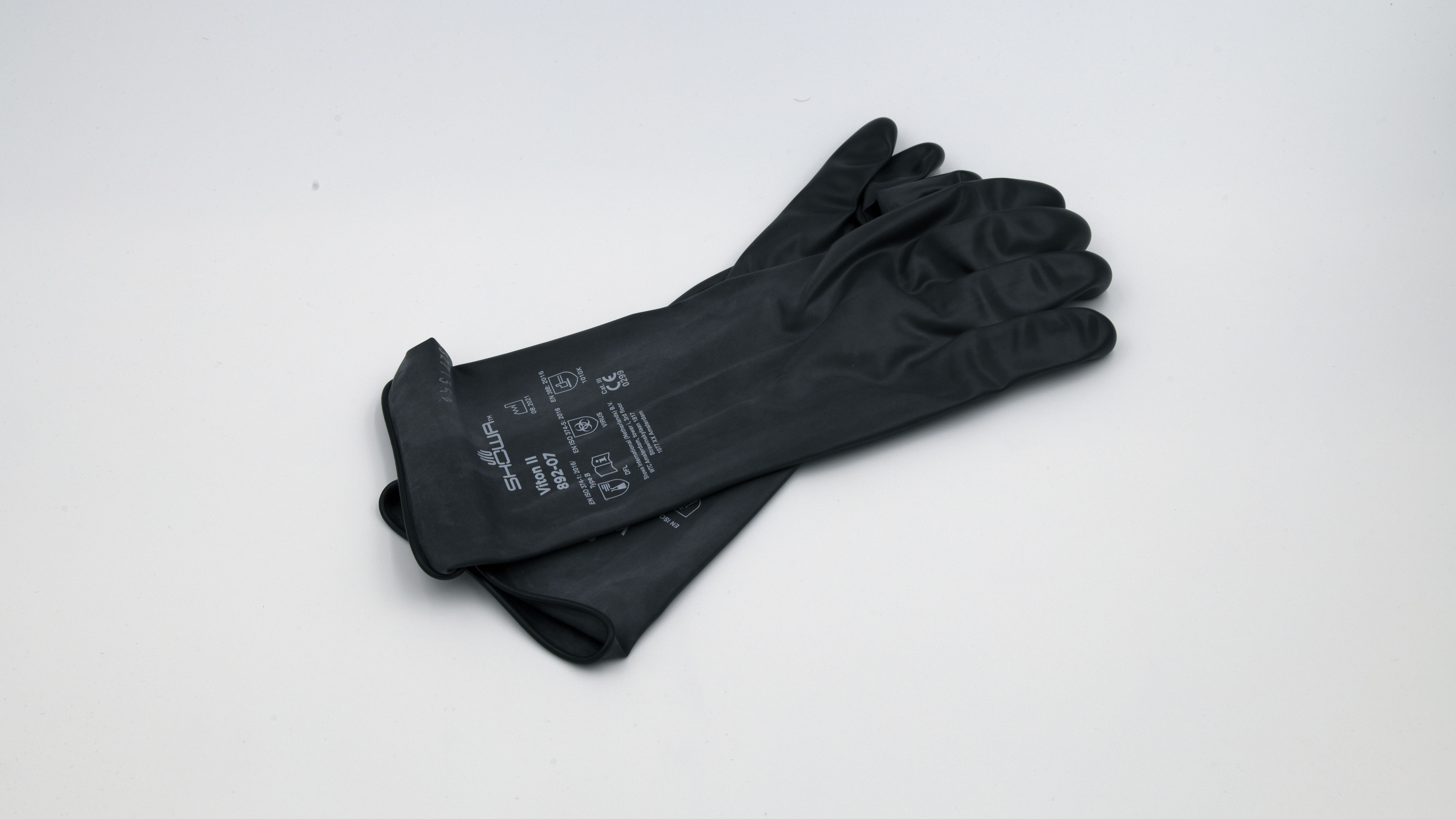 Black rubber gloves on white background