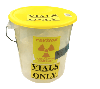 Image of a plastic pale labeled "radioactive vial waste"